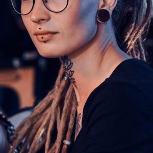 beautiful-creative-master-with-dreadlocks-is-working-new-peace-big-leg-tattoo-customer_613910-2929